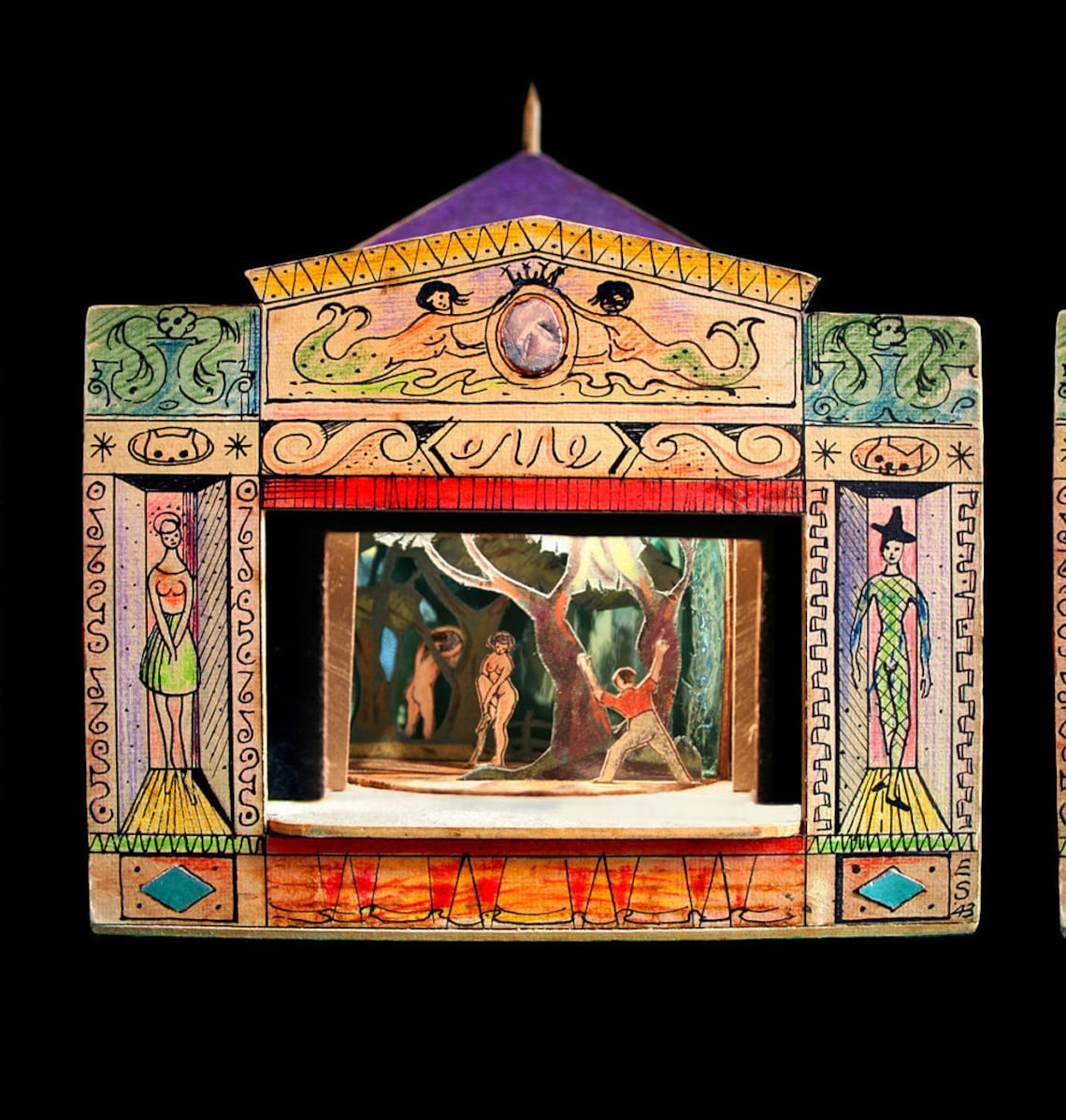 A photograph of a toy theatre, featuring a risque scene on the stage, where a clothed man discovers two nude women  in the woods.
